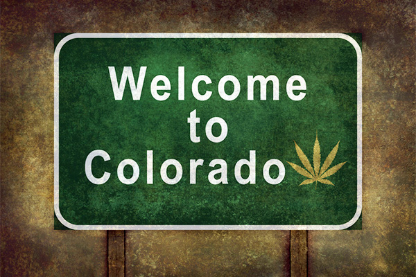 Welcome to Colorado (with marijuana leaf symbol) roadside sign